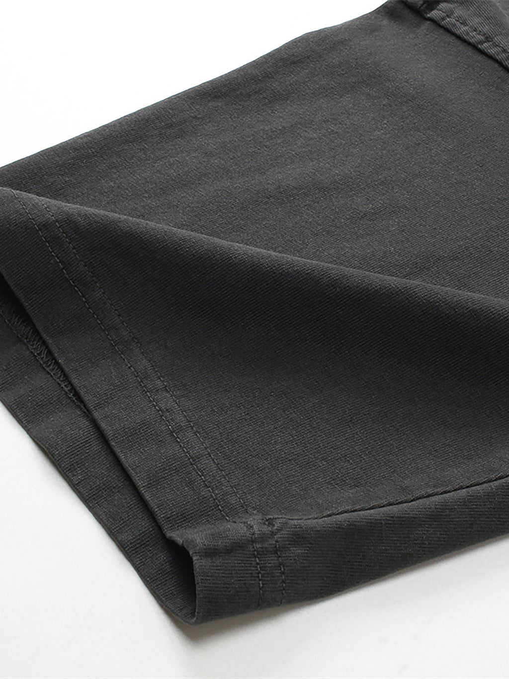 Folded black pants on a white background