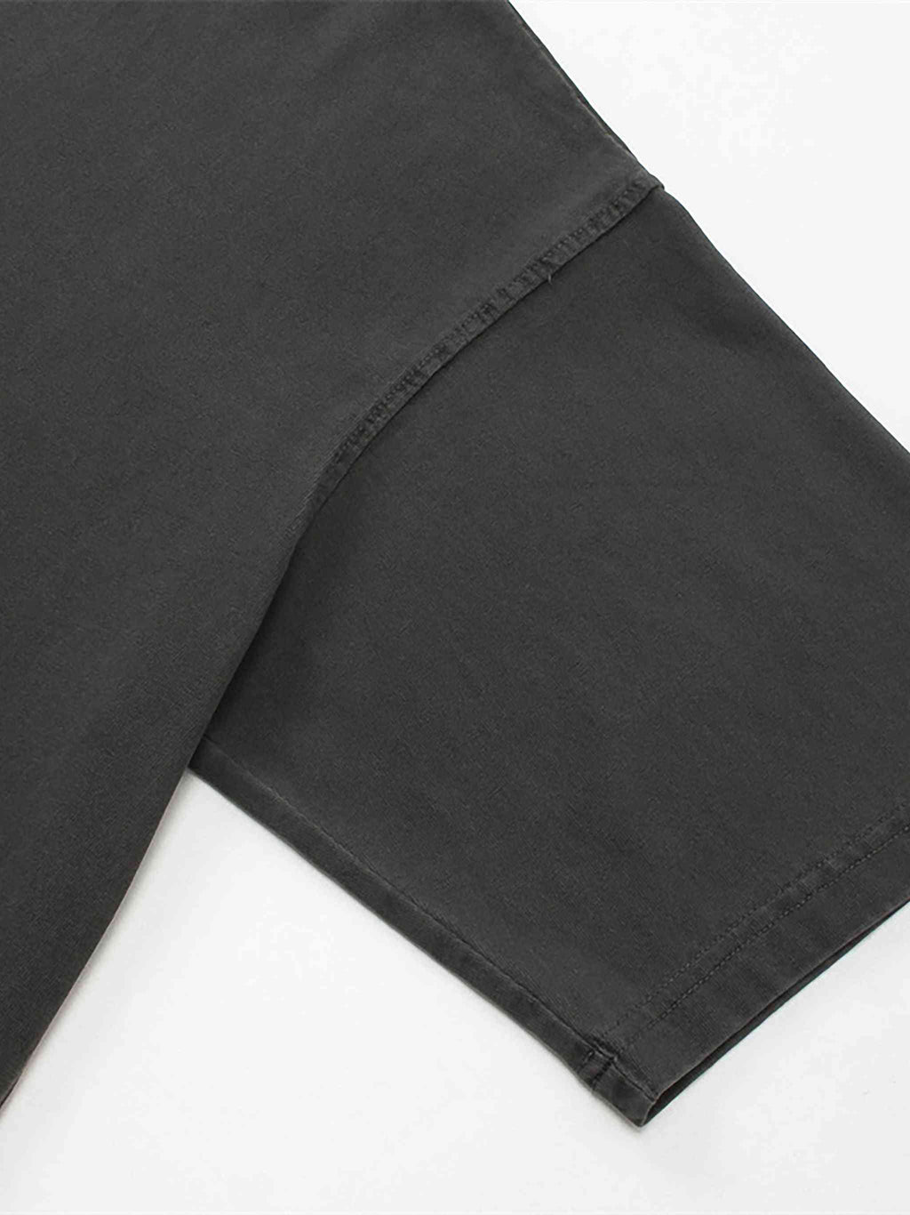 Close-up of black pants on a white background