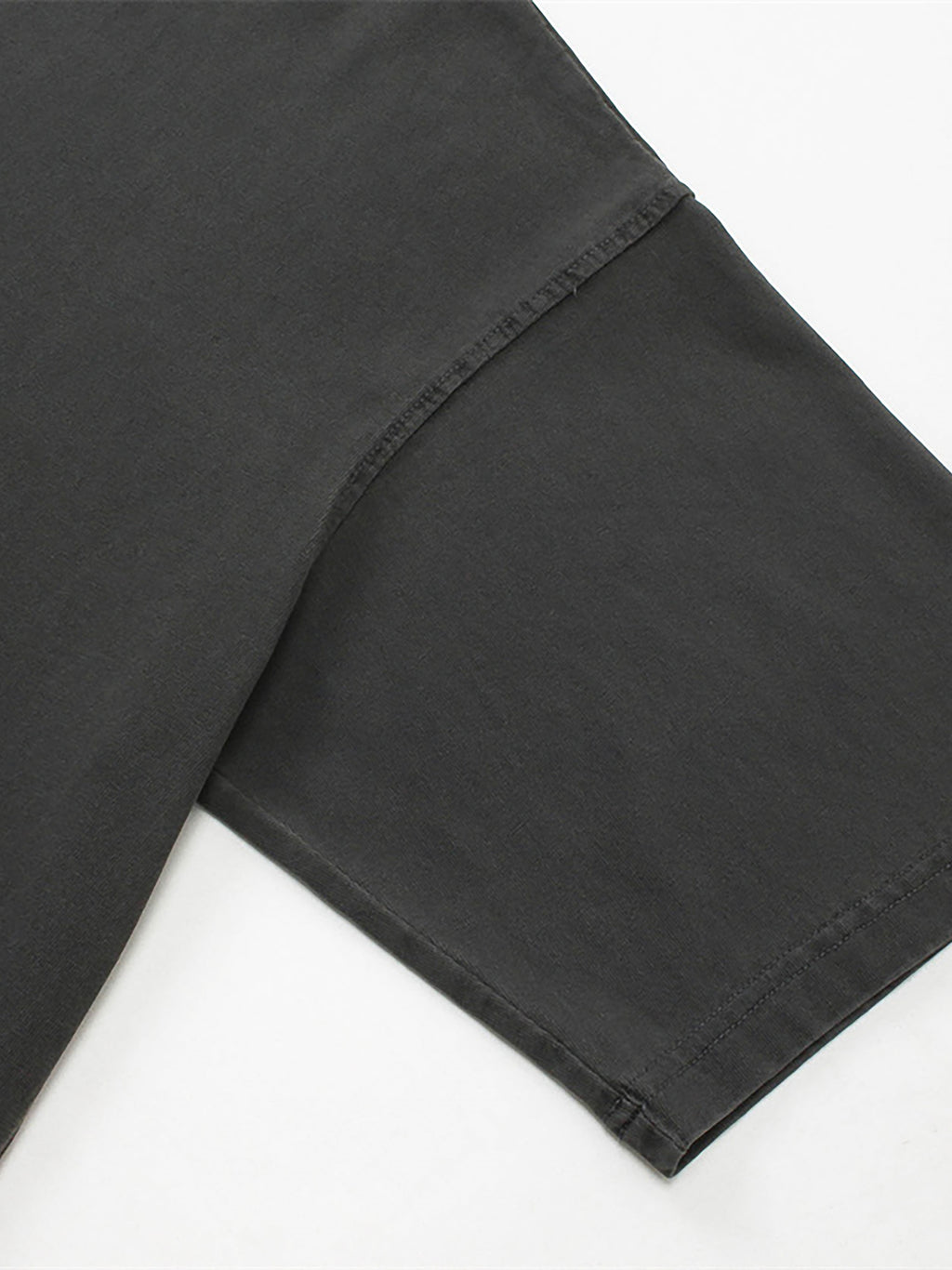 Close-up of black pants on a white background