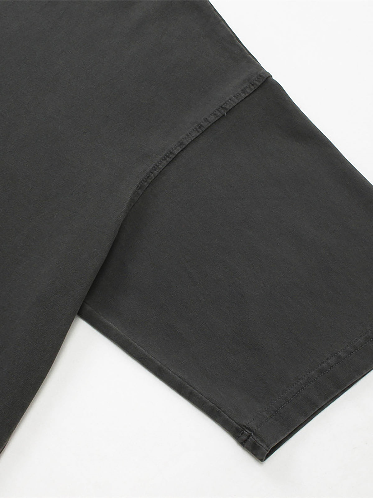 Close-up of black pants on a white background
