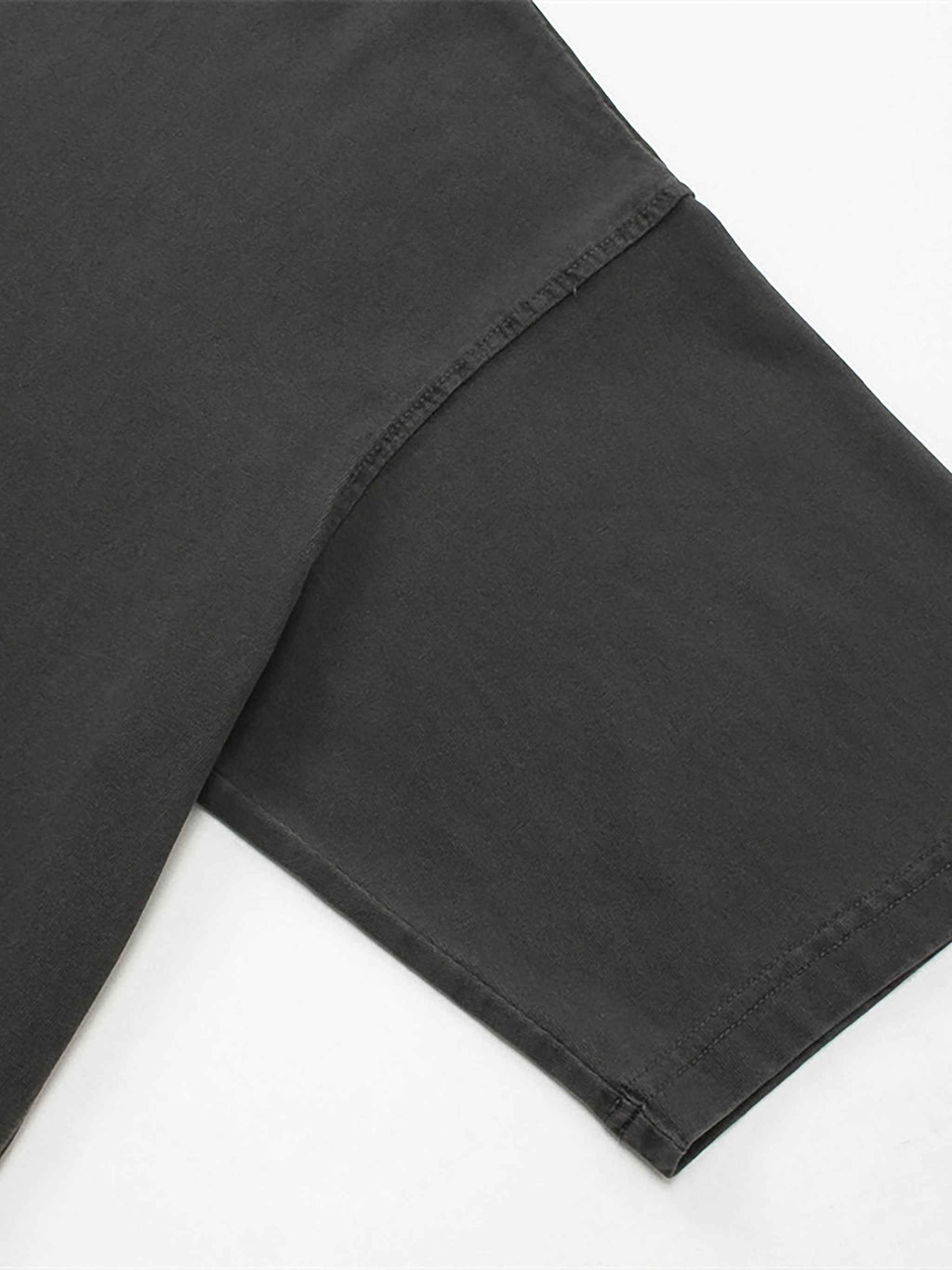 Close-up of black pants on a white background