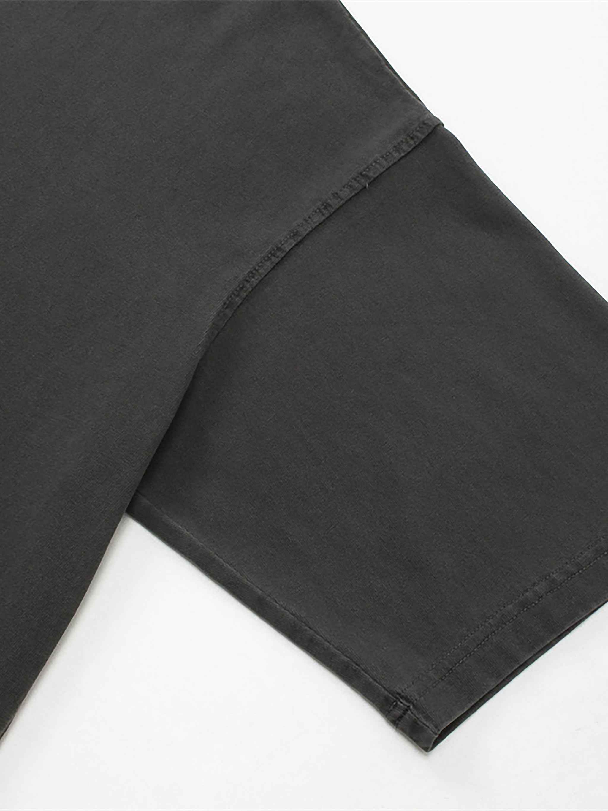 Close-up of black pants on a white background