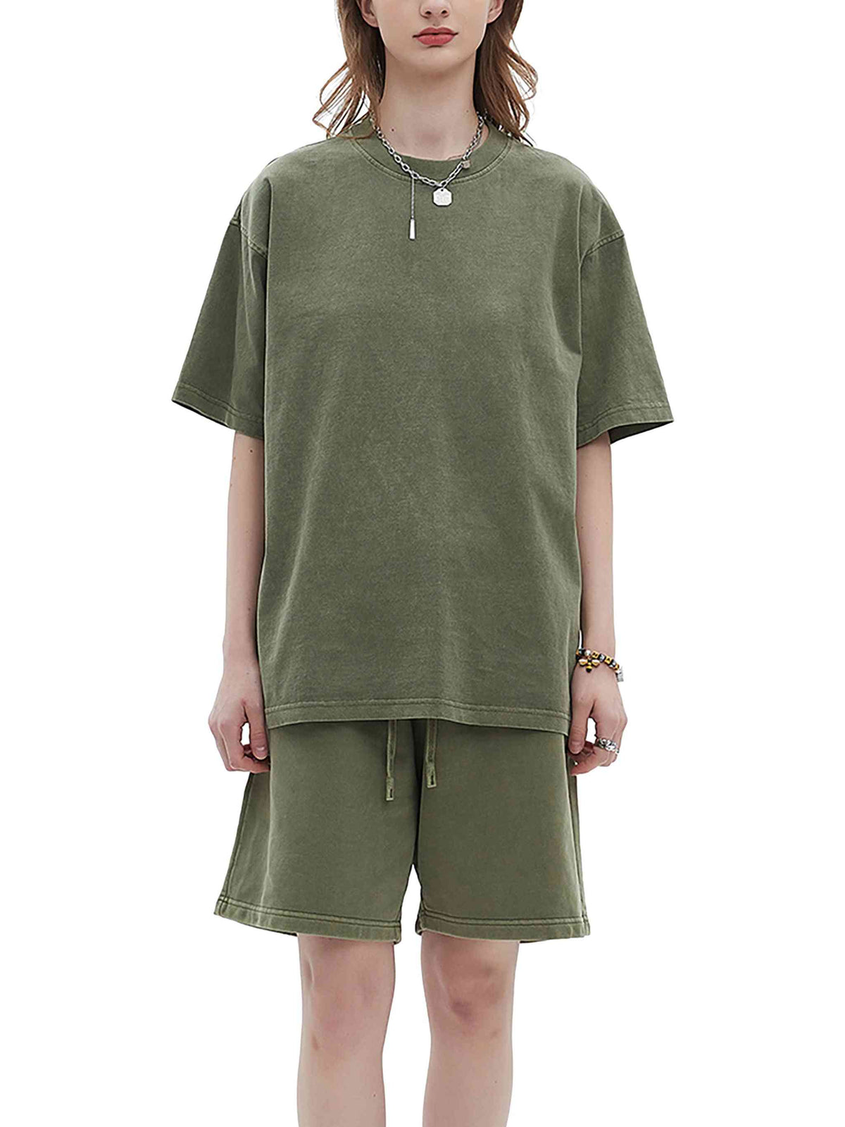 Person wearing an olive green t-shirt and shorts set on a white background