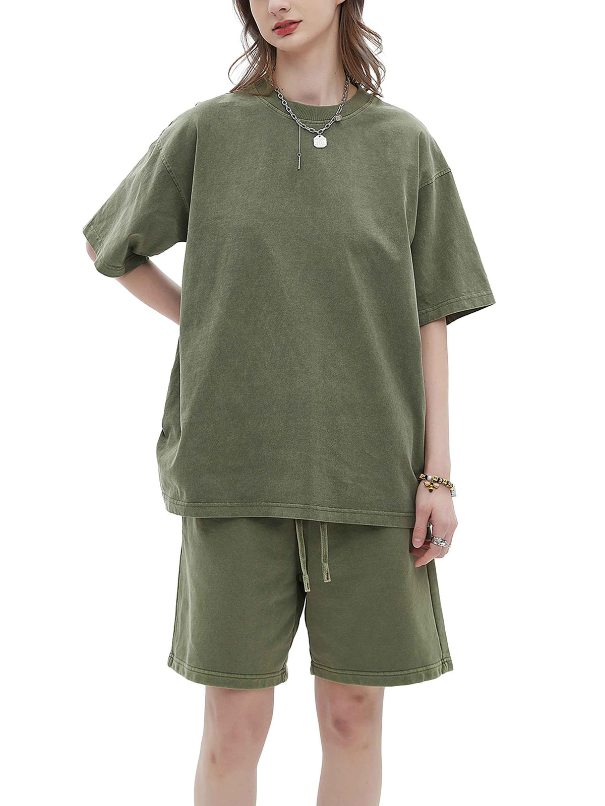 Person wearing an olive green outfit with a t-shirt and shorts on a white background