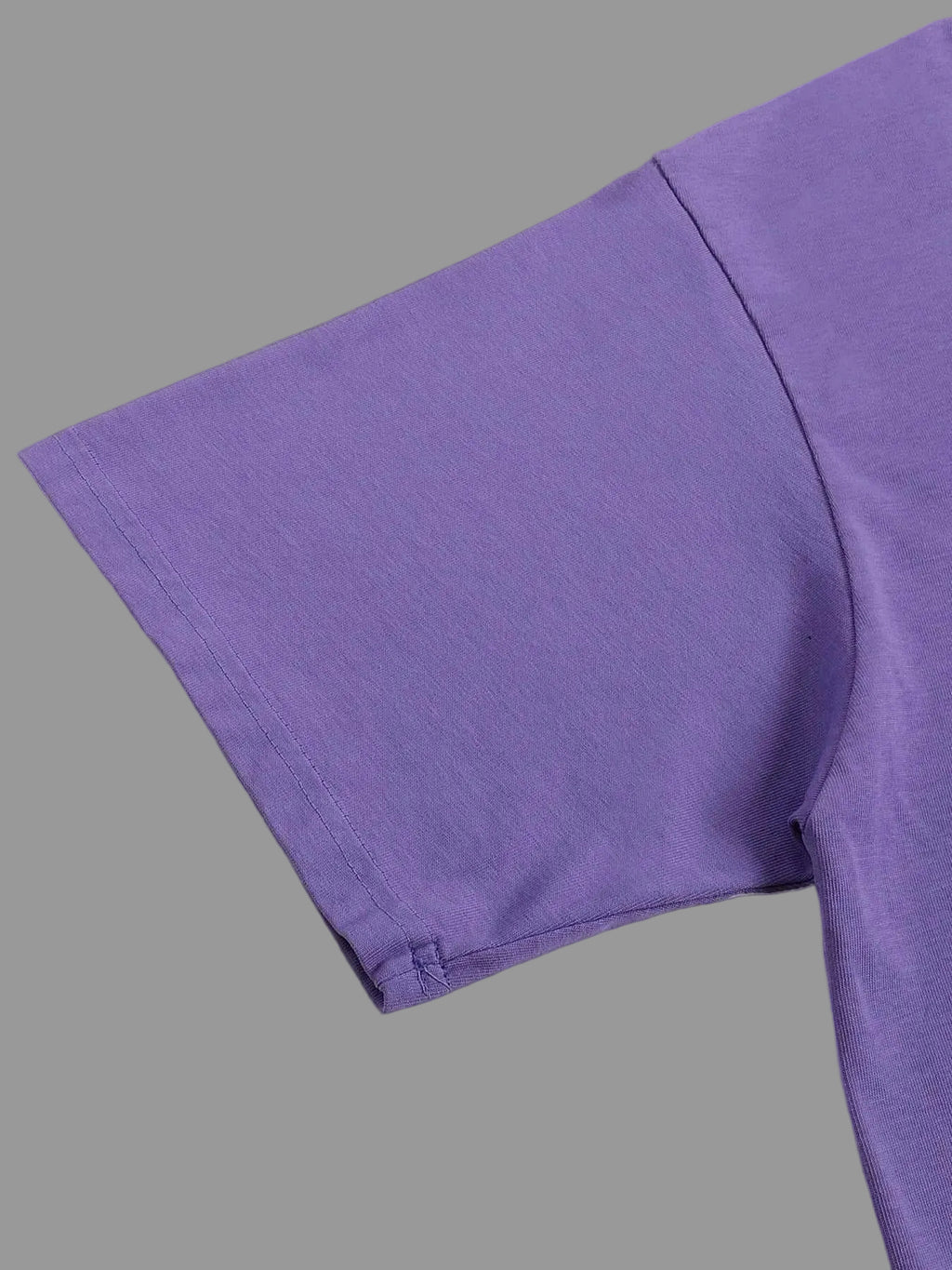 Close-up of a purple fabric texture on a gray background