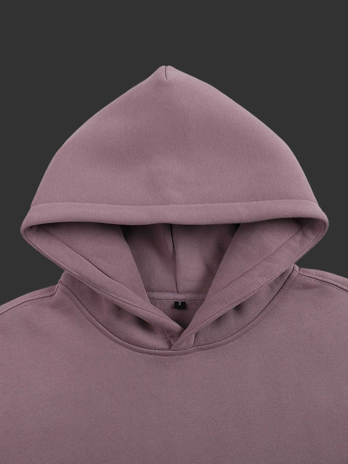 Close-up of a purple hoodie with a hood on a gray background