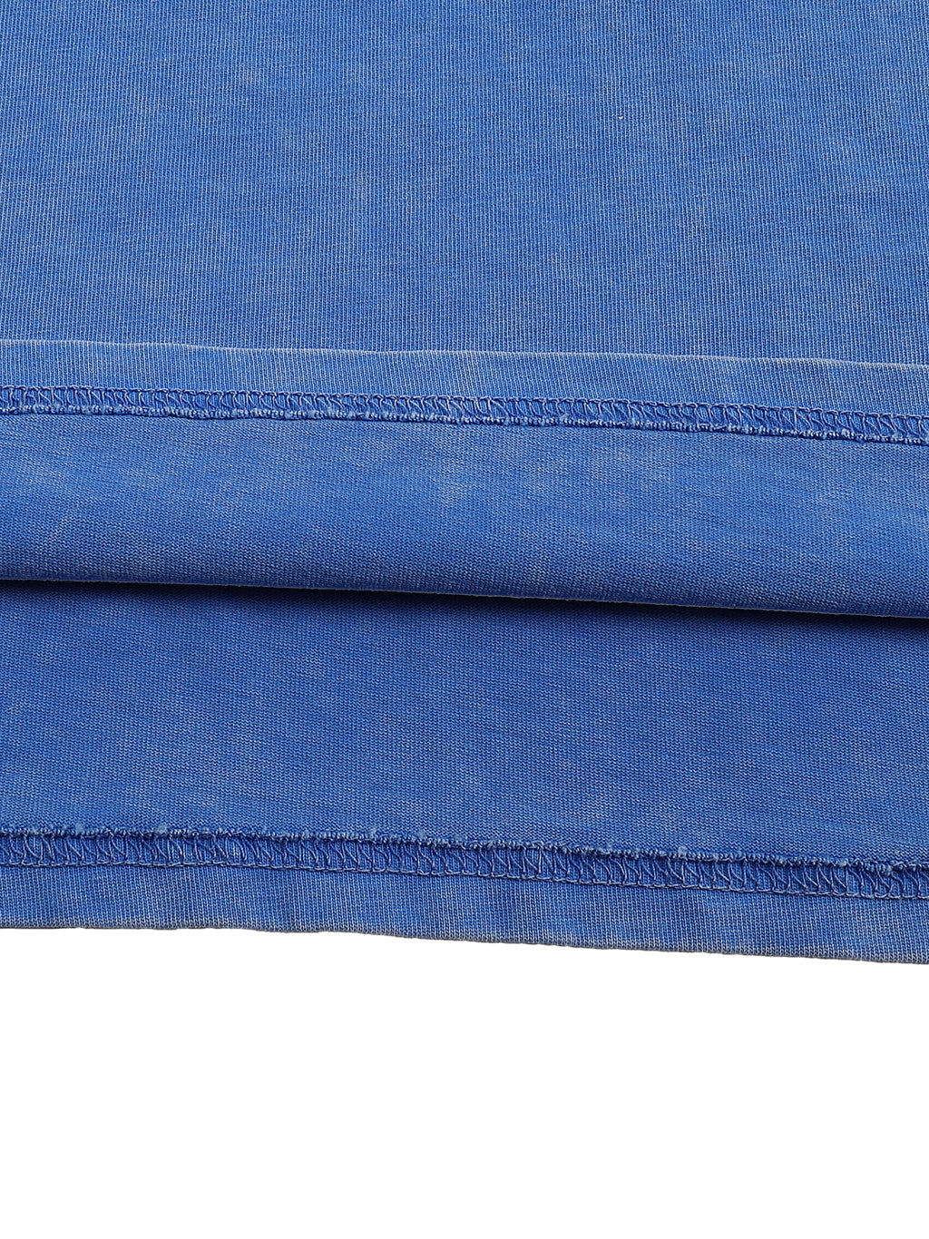 Close-up of blue fabric with a visible seam on a white background