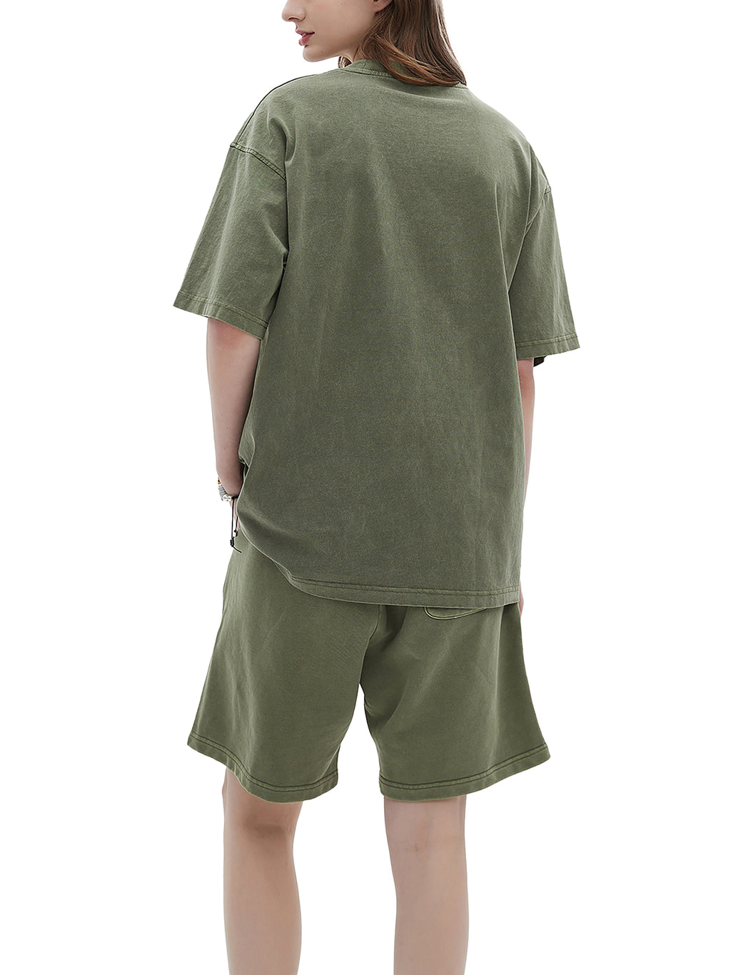 Person wearing an olive green oversized t-shirt and shorts set on a white background