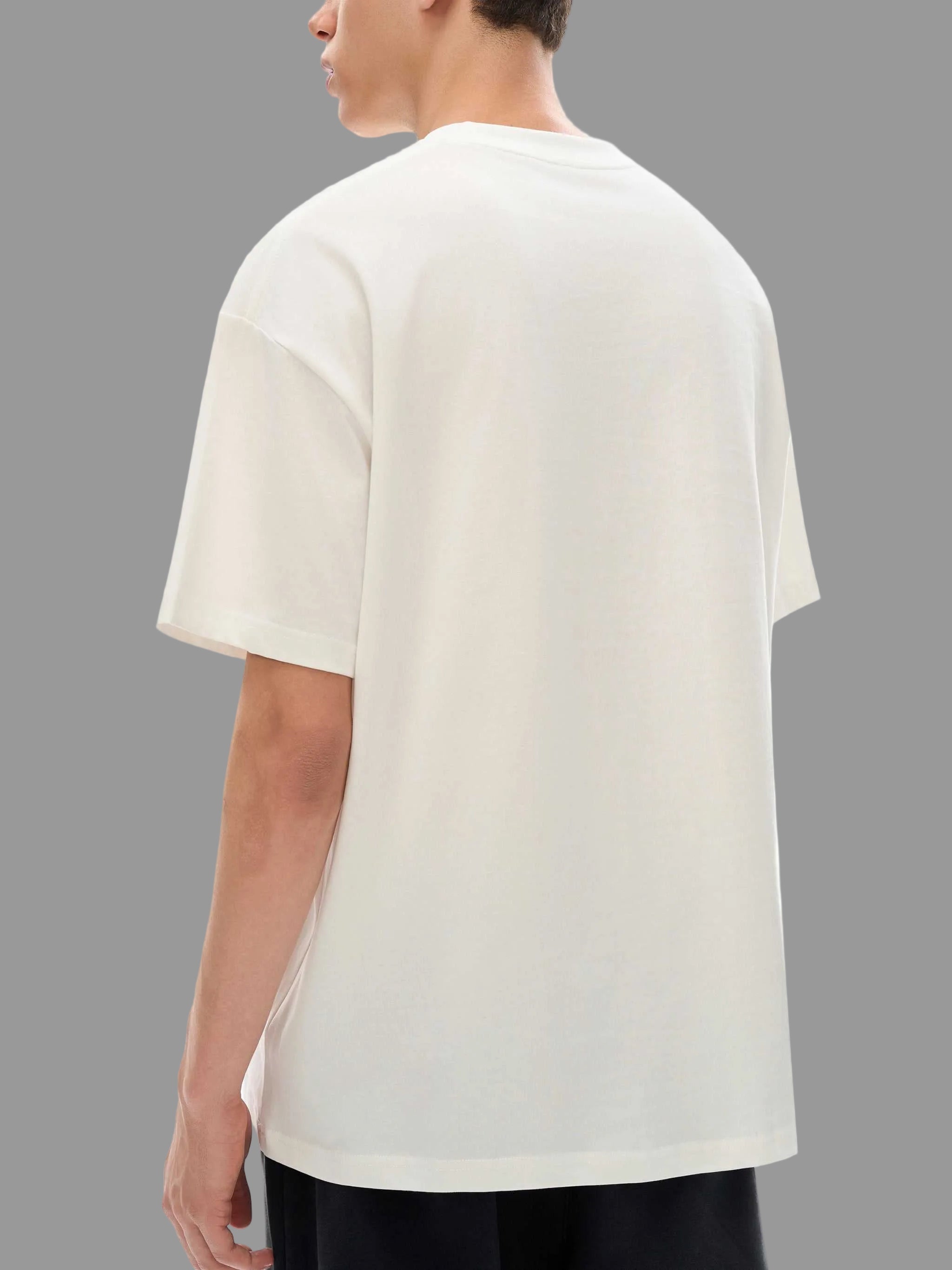 Person wearing a plain white t-shirt on a gray background