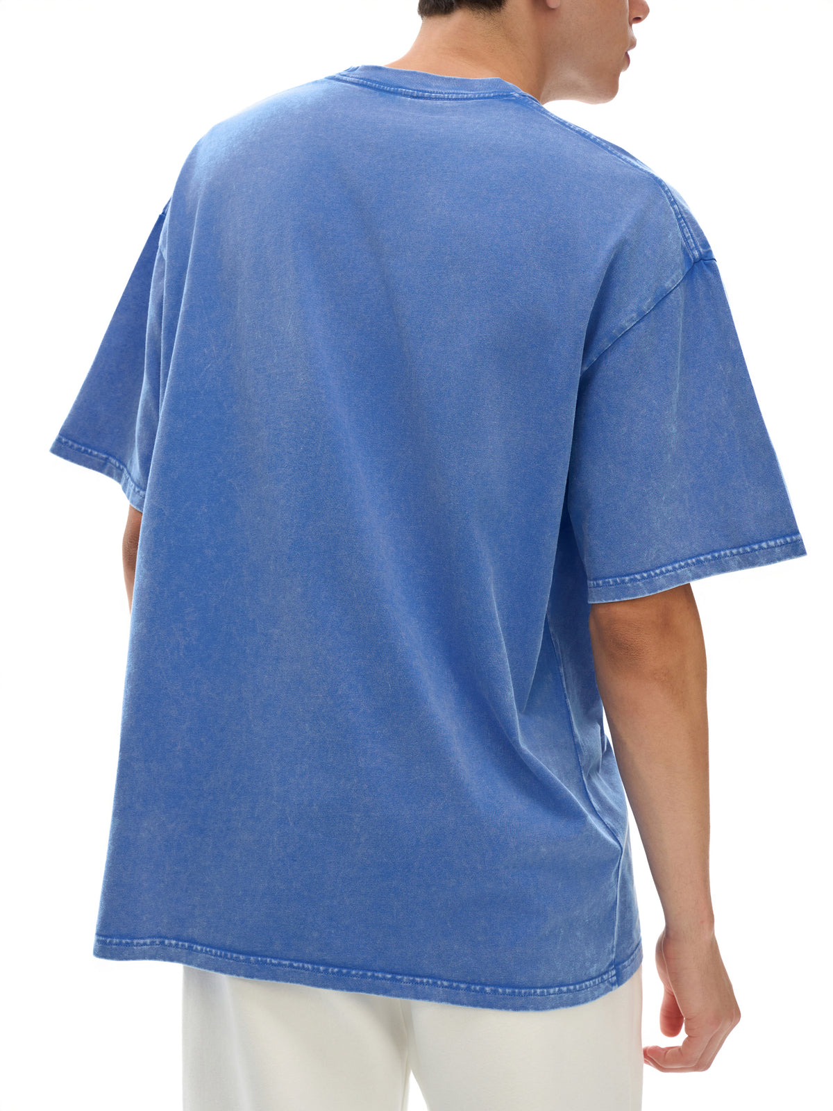 Blue t-shirt worn by a person on a white background